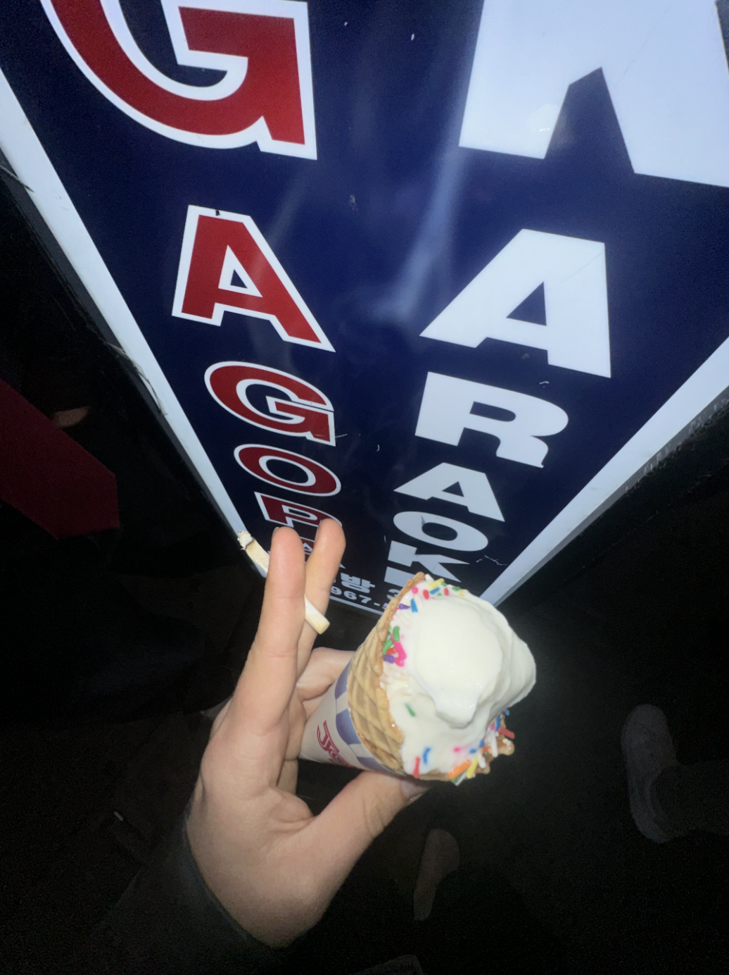 ice cream cone in front of a karaoke sign